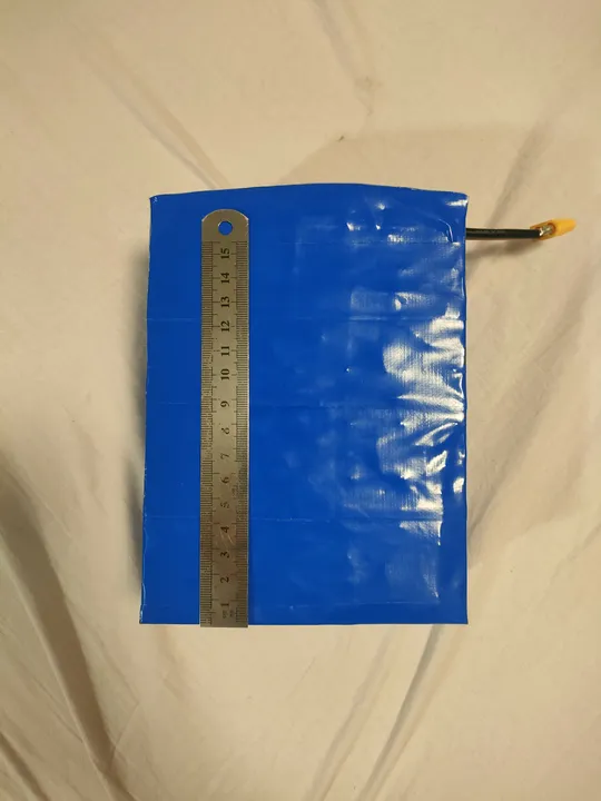 Side view of the battery pack next to a ruler