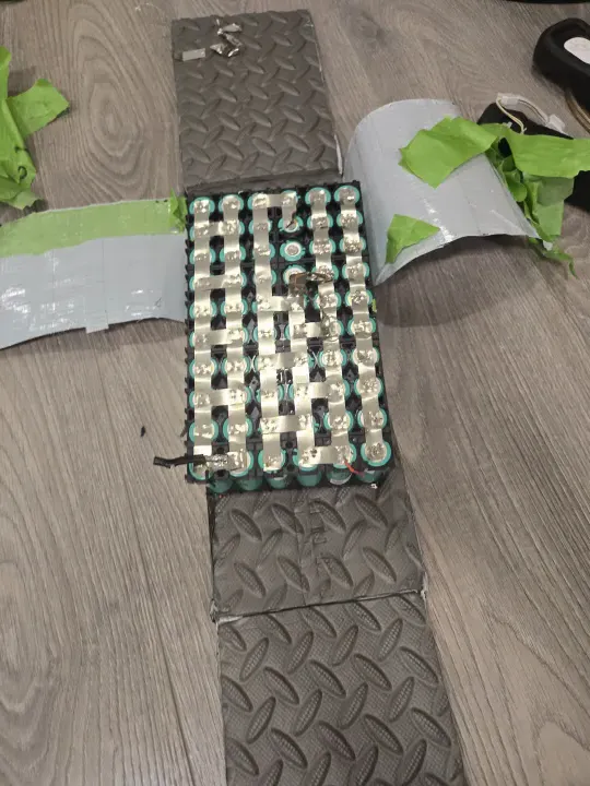 Battery pack disassembled, showing the internal cell layout