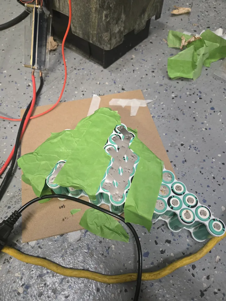 Another view of the spot welding process on the battery